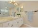 Bathroom with a tiled shower/bath combo, a granite sink, and decor throughout at 1144 Lanyard St, Palm Harbor, FL 34685