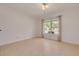 Bedroom featuring neutral walls, tile floors, and a large window with curtains allowing natural light at 1144 Lanyard St, Palm Harbor, FL 34685