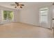 Neutral bedroom with two windows allowing for ample natural light and neutral tile flooring at 1144 Lanyard St, Palm Harbor, FL 34685