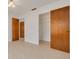 This bedroom features tile floors, white walls, and a closet with sliding wooden doors at 1144 Lanyard St, Palm Harbor, FL 34685