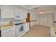 Functional kitchen with white cabinetry and appliances and a storage area at 1144 Lanyard St, Palm Harbor, FL 34685
