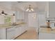 Well-lit kitchen featuring white appliances, countertops, and a view into the living and dining spaces at 1144 Lanyard St, Palm Harbor, FL 34685