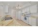 Bright kitchen with white cabinets and appliances, offering ample counter space and a seamless layout at 1144 Lanyard St, Palm Harbor, FL 34685