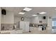 Bright kitchen featuring ample countertop space, white cabinetry, and all essential appliances at 1144 Lanyard St, Palm Harbor, FL 34685