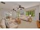 Inviting living room with comfortable seating, ceiling fans, and a view into the dining area at 1144 Lanyard St, Palm Harbor, FL 34685