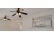 Open living space with ceiling fans and a view through the bar to the kitchen at 1144 Lanyard St, Palm Harbor, FL 34685