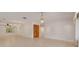 Bright and airy living room featuring tiled flooring, elegant lighting, and neutral walls at 1144 Lanyard St, Palm Harbor, FL 34685