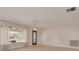 Bright living room featuring large windows, neutral walls, tile floors, and an ornate chandelier at 1144 Lanyard St, Palm Harbor, FL 34685