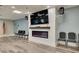 Relaxing lounge area with a large television, electric fireplace, and comfortable seating at 1144 Lanyard St, Palm Harbor, FL 34685