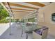 Covered patio area with tables and chairs for outdoor dining and relaxation at 1144 Lanyard St, Palm Harbor, FL 34685