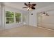 Bright sun room with tile floors, a unique ceiling fan, and natural light from the glass windows and door to the outside at 1144 Lanyard St, Palm Harbor, FL 34685