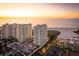 Aerial view featuring luxurious high-rise residences with stunning sunset ocean views and lush landscape at 1170 Gulf Blvd # 402, Clearwater, FL 33767