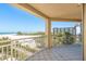 Enjoy a relaxing view of the beach from the tiled balcony, a perfect spot to unwind and enjoy the outdoors at 1170 Gulf Blvd # 402, Clearwater, FL 33767