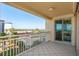 The balcony features a tiled floor and a view of the parking area and the community's lush tropical foliage at 1170 Gulf Blvd # 402, Clearwater, FL 33767
