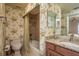 Cozy bathroom featuring floral wallpaper, a granite sink, and a shower-tub combination at 1170 Gulf Blvd # 402, Clearwater, FL 33767