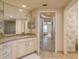 Bright bathroom with a view to the bedroom, featuring granite countertops and tiled floors at 1170 Gulf Blvd # 402, Clearwater, FL 33767