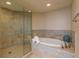 Beautiful bathroom with a glass enclosed shower and soaking tub with tile accents at 1170 Gulf Blvd # 402, Clearwater, FL 33767