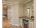 Bathroom vanity with granite countertop, storage, and makeup mirror at 1170 Gulf Blvd # 402, Clearwater, FL 33767