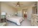 Comfortable bedroom with neutral tones, ceiling fan, and view to ensuite bathroom at 1170 Gulf Blvd # 402, Clearwater, FL 33767