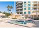 Relax by the beautiful community pool and hot tub surrounded by tropical landscaping and amenities at 1170 Gulf Blvd # 402, Clearwater, FL 33767