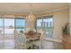 The dining area includes waterfront views and sliding glass doors to the balcony at 1170 Gulf Blvd # 402, Clearwater, FL 33767