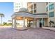 The entrance to the building features a brick drive and covered entrance with columns at 1170 Gulf Blvd # 402, Clearwater, FL 33767