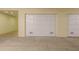 A secure garage space featuring a white door and ample parking for your vehicle at 1170 Gulf Blvd # 402, Clearwater, FL 33767