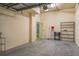 Spacious garage with shelves and access door, offering secure parking and extra storage solutions at 1170 Gulf Blvd # 402, Clearwater, FL 33767