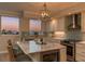 Modern kitchen with granite countertops, stainless steel appliances, and water view at 1170 Gulf Blvd # 402, Clearwater, FL 33767