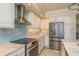 Modern kitchen features stainless appliances, granite countertops, and tile backsplash at 1170 Gulf Blvd # 402, Clearwater, FL 33767