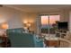 Cozy living room with comfortable seating and sliding glass doors with ocean view at 1170 Gulf Blvd # 402, Clearwater, FL 33767