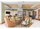 Spacious living room features an area rug, coffered ceilings, television, and multiple seating options at 1170 Gulf Blvd # 402, Clearwater, FL 33767