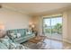 This living room features tile flooring, comfortable seating, and direct access to the balcony at 1170 Gulf Blvd # 402, Clearwater, FL 33767