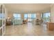 The open-concept living and dining area with water views, tile floors, and crown molding at 1170 Gulf Blvd # 402, Clearwater, FL 33767