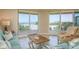 The living room features tile floors, comfortable seating, and private balcony access at 1170 Gulf Blvd # 402, Clearwater, FL 33767
