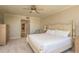 Main bedroom with neutral decor, ceiling fan, and ensuite bathroom at 1170 Gulf Blvd # 402, Clearwater, FL 33767