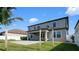 Large backyard with a lawn, patio and palm trees at 11720 Navajo Sandstone St, Riverview, FL 33579