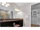 Bathroom featuring double sinks, granite countertops, and access to walk-in closet at 11720 Navajo Sandstone St, Riverview, FL 33579