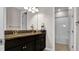 Bathroom with double sink vanity with granite countertop, and a shower/tub combo at 11720 Navajo Sandstone St, Riverview, FL 33579