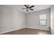 Bright bedroom with hardwood floors, ceiling fan, and natural light from a window at 11720 Navajo Sandstone St, Riverview, FL 33579