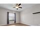 Bedroom with hardwood floors, a window with curtains, and a ceiling fan at 11720 Navajo Sandstone St, Riverview, FL 33579