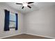 Clean bedroom with ceiling fan, window with blinds and curtains and wood-look flooring at 11720 Navajo Sandstone St, Riverview, FL 33579