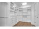 Walk-in closet with custom shelving, drawers, and ample storage space at 11720 Navajo Sandstone St, Riverview, FL 33579
