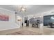 Open-concept kitchen with gray cabinets, pendant lighting, granite countertops, and stainless appliances at 11720 Navajo Sandstone St, Riverview, FL 33579