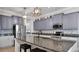 Well-equipped kitchen featuring granite countertops, stainless steel appliances, and a functional island at 11720 Navajo Sandstone St, Riverview, FL 33579