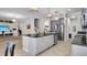 Kitchen island featuring granite countertops, gray cabinets, stainless appliances, and tiled floor at 11720 Navajo Sandstone St, Riverview, FL 33579