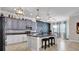 Beautiful kitchen showcasing gray cabinets, granite counters, decorative backsplash, and center island with seating at 11720 Navajo Sandstone St, Riverview, FL 33579