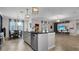 Bright kitchen with granite countertops, stainless steel appliances, and adjacent dining and living areas at 11720 Navajo Sandstone St, Riverview, FL 33579