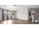 Bright, open living room features hardwood floors, modern lighting, and large windows at 11720 Navajo Sandstone St, Riverview, FL 33579