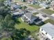 Aerial view of home and backyard featuring green grass and a deck with neighborhood views at 11780 Linden Dr, Spring Hill, FL 34608